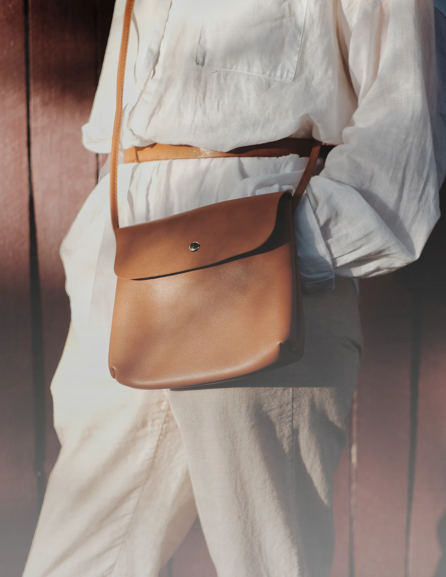 Leather satchel and clothing illustrating custom clothing and accessories